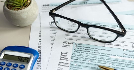 Blank US Individual income tax return and a calculator