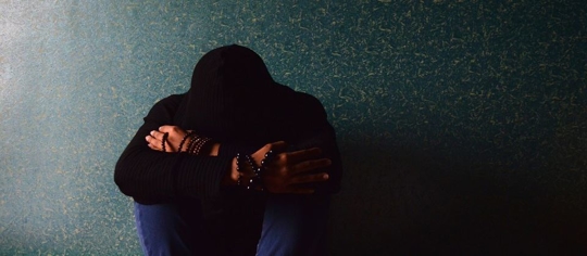 Young person covering their head